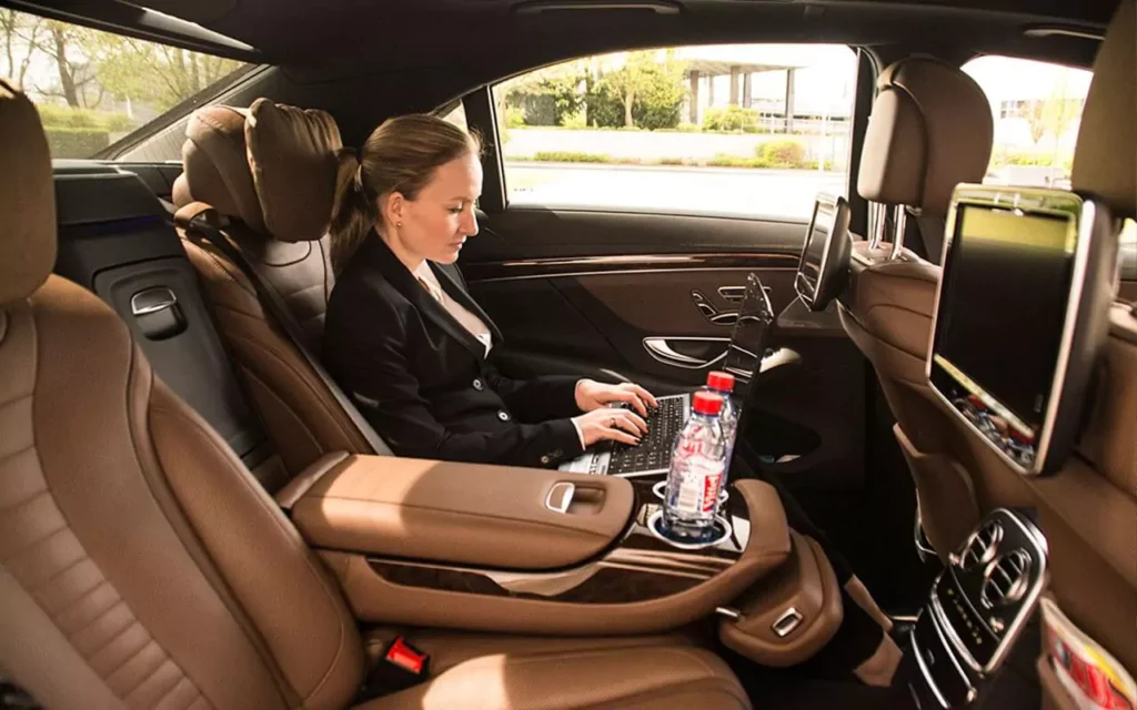 Businesswoman working in RideMate UK executive car.